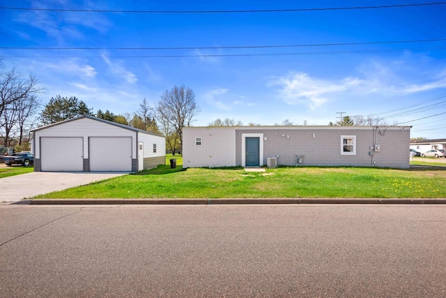 657 Elm St, Black River Falls, WI 54615 - view of front facade with a detached garage, an outdoor structure, and a front lawn