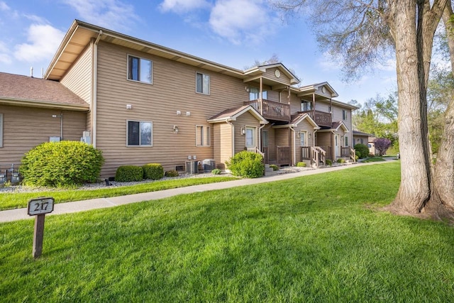 view of front of home with a front lawn and a balcony