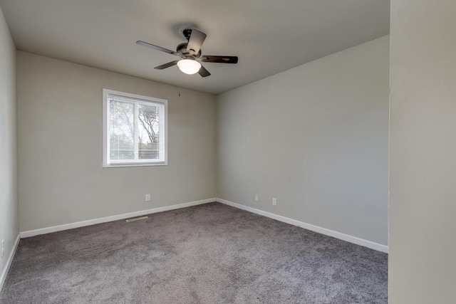 spare room with carpet floors, baseboards, and ceiling fan