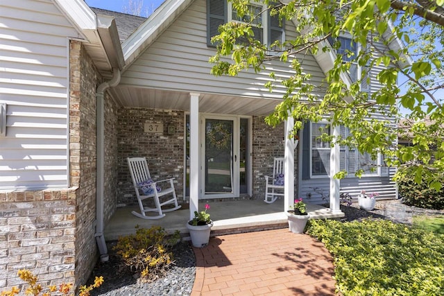 37 Pheasant Ct, Appleton, WI 54915 - doorway to property featuring a porch and brick siding