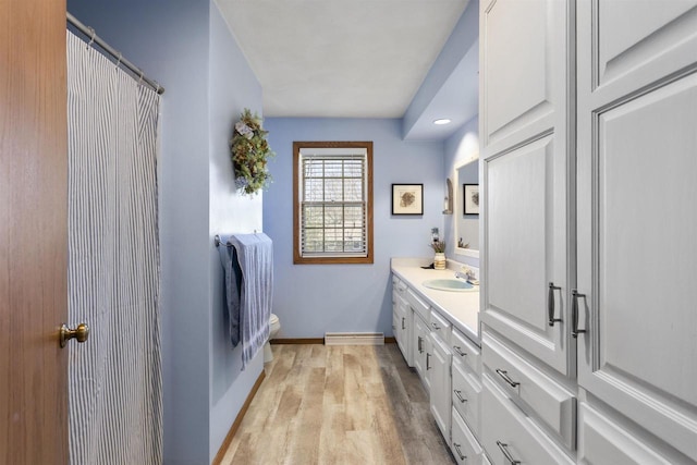 37 Pheasant Ct, Appleton, WI 54915 - bathroom with vanity, toilet, wood finished floors, baseboards, and curtained shower
