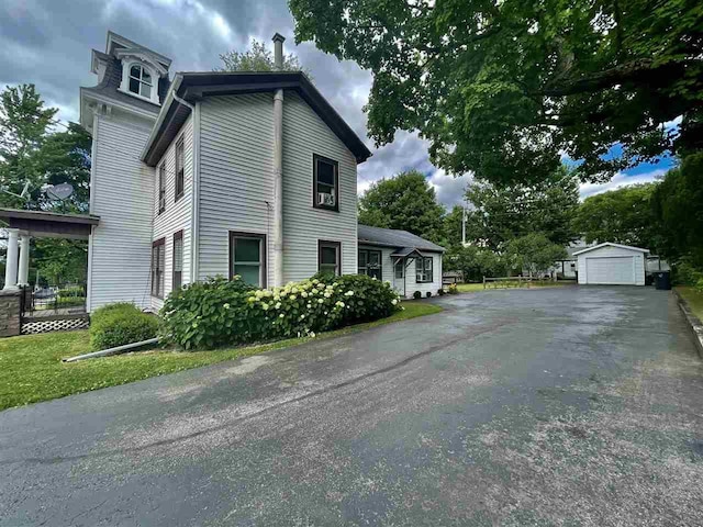 180 N Wisconsin St, Berlin, WI 54923 - view of side of property featuring a detached garage and an outbuilding
