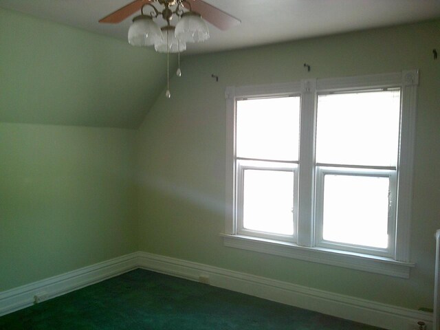 2309 Jefferson St, Two Rivers, WI 54241 - additional living space with ceiling fan, baseboards, dark colored carpet, and vaulted ceiling
