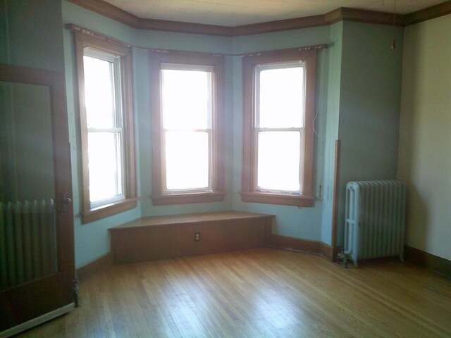 2309 Jefferson St, Two Rivers, WI 54241 - empty room featuring radiator, wood finished floors, and baseboards