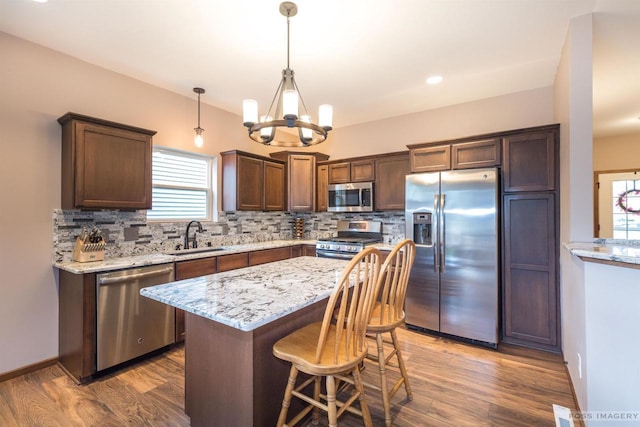 222 Blooming Leaf Way, Verona, WI 53593 - kitchen with appliances with stainless steel finishes, a sink, decorative backsplash, and a chandelier