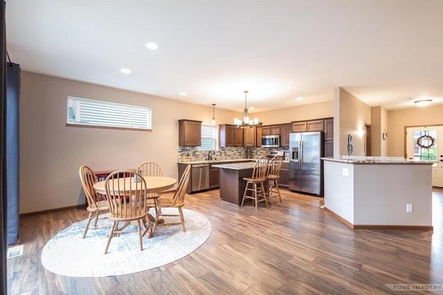 222 Blooming Leaf Way, Verona, WI 53593 - dining area featuring healthy amount of natural light, dark wood finished floors, recessed lighting, a chandelier, and baseboards