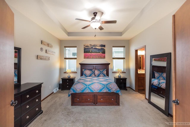 222 Blooming Leaf Way, Verona, WI 53593 - bedroom featuring a raised ceiling, light carpet, baseboards, ceiling fan, and connected bathroom