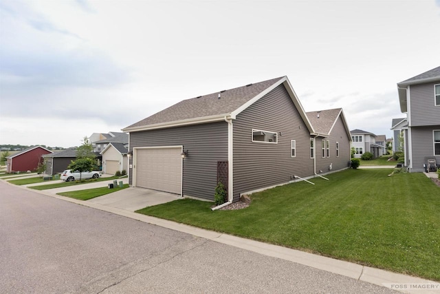 222 Blooming Leaf Way, Verona, WI 53593 - view of side of home with a residential view, a lawn, concrete driveway, and a shingled roof