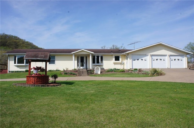 ranch-style house featuring a front yard, driveway, and an attached garage