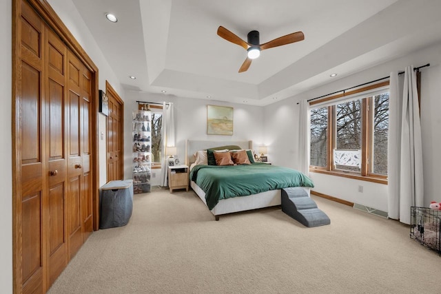 2108 Lawrence Dr, De Pere, WI 54115 - bedroom with light carpet, a raised ceiling, ceiling fan, recessed lighting, and baseboards