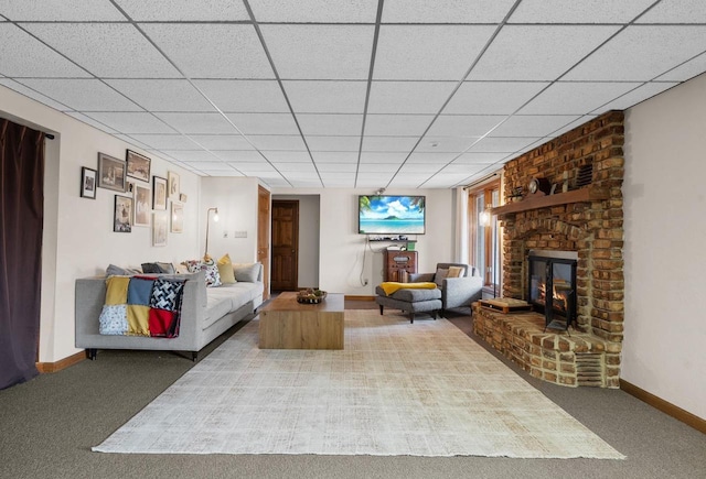 2108 Lawrence Dr, De Pere, WI 54115 - living room featuring a brick fireplace, baseboards, carpet, and a paneled ceiling