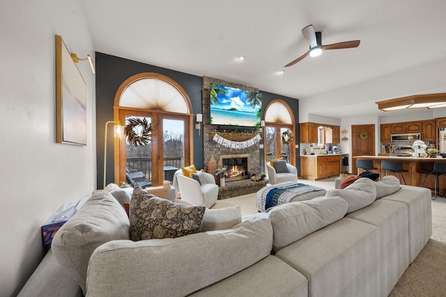 2108 Lawrence Dr, De Pere, WI 54115 - living area with light carpet, a brick fireplace, ceiling fan, and plenty of natural light