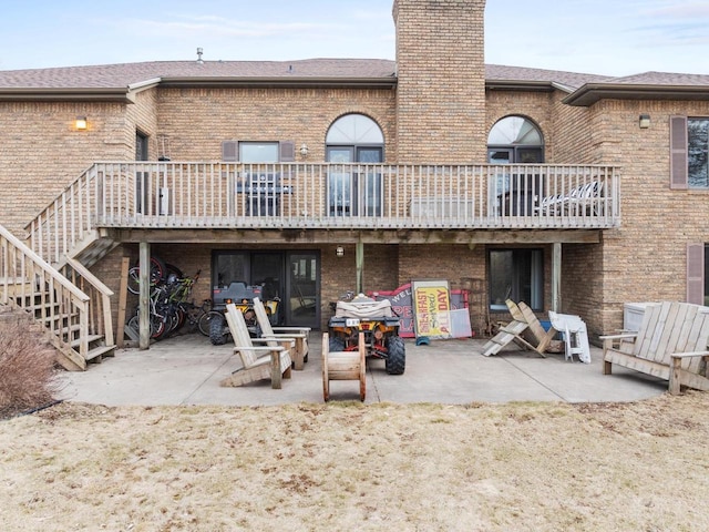 2108 Lawrence Dr, De Pere, WI 54115 - back of property featuring brick siding, a patio area, a chimney, and stairway