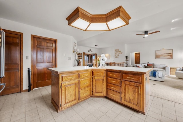 2108 Lawrence Dr, De Pere, WI 54115 - kitchen with open floor plan, light countertops, a ceiling fan, light tile patterned flooring, and a center island