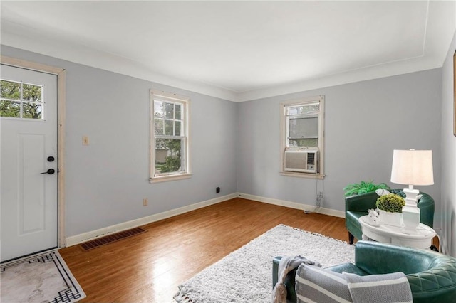 entrance foyer with plenty of natural light, wood finished floors, cooling unit, and baseboards