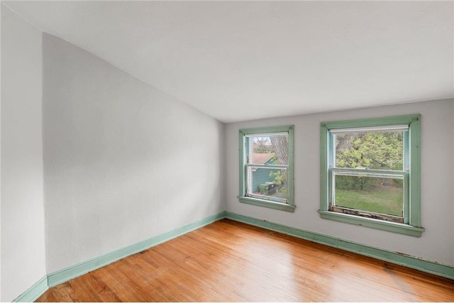 unfurnished room featuring light wood-type flooring and baseboards