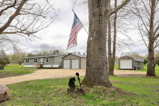 W5977 Lakeview Dr, Montello, WI 53949 - view of front facade featuring an outdoor structure, driveway, and a front yard