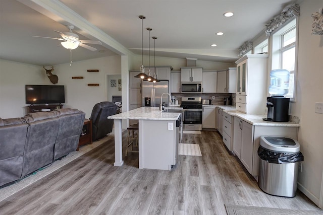 W5977 Lakeview Dr, Montello, WI 53949 - kitchen featuring appliances with stainless steel finishes, open floor plan, lofted ceiling, a breakfast bar area, and light wood-style flooring