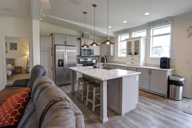 W5977 Lakeview Dr, Montello, WI 53949 - kitchen featuring stainless steel appliances, a sink, a kitchen breakfast bar, open floor plan, and light wood finished floors