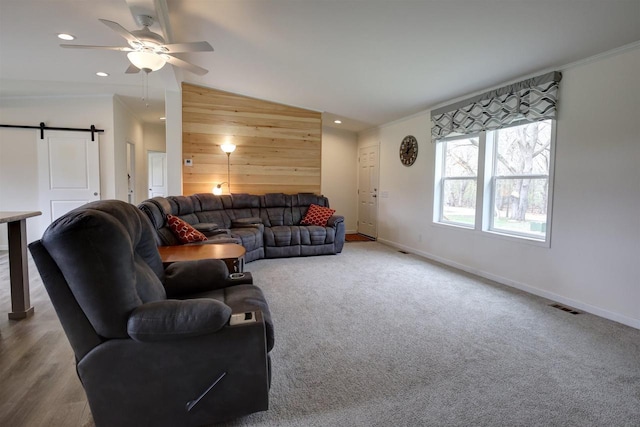 W5977 Lakeview Dr, Montello, WI 53949 - carpeted living room featuring wooden walls, baseboards, a barn door, ceiling fan, and recessed lighting