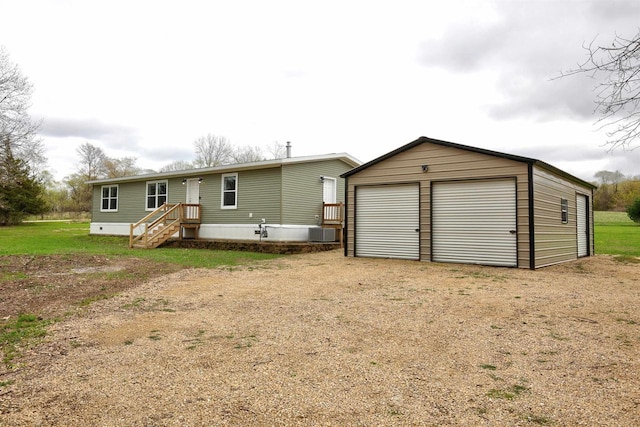 W5977 Lakeview Dr, Montello, WI 53949 - back of property with a detached garage, an outdoor structure, and central AC