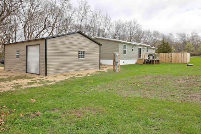 W5977 Lakeview Dr, Montello, WI 53949 - rear view of property with a lawn, an outbuilding, and a deck