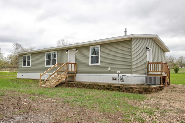 W5977 Lakeview Dr, Montello, WI 53949 - back of property featuring central AC unit and a yard