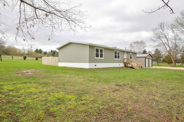 W5977 Lakeview Dr, Montello, WI 53949 - rear view of property featuring an outbuilding, a yard, a detached garage, and crawl space