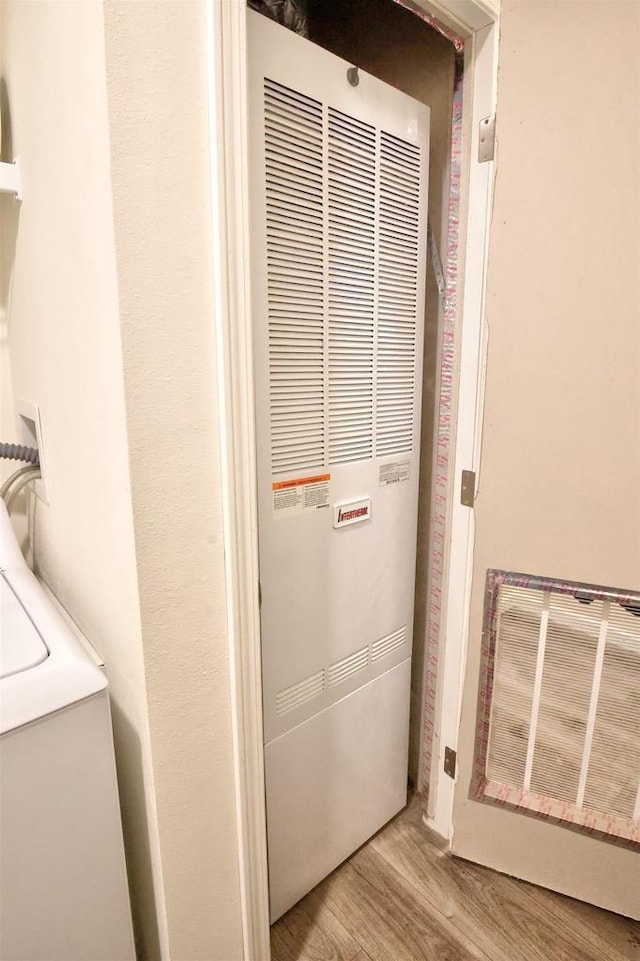 W5977 Lakeview Dr, Montello, WI 53949 - laundry view of a heating unit, wood finished floors, and washer / clothes dryer