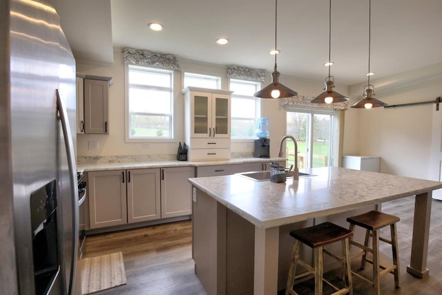 W5977 Lakeview Dr, Montello, WI 53949 - kitchen featuring stainless steel fridge, a sink, healthy amount of natural light, a breakfast bar, and recessed lighting
