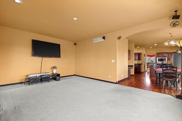 N109W14760 Preserve Pkwy, Germantown, WI 53022 - living room with arched walkways, dark carpet, baseboards, recessed lighting, and a chandelier