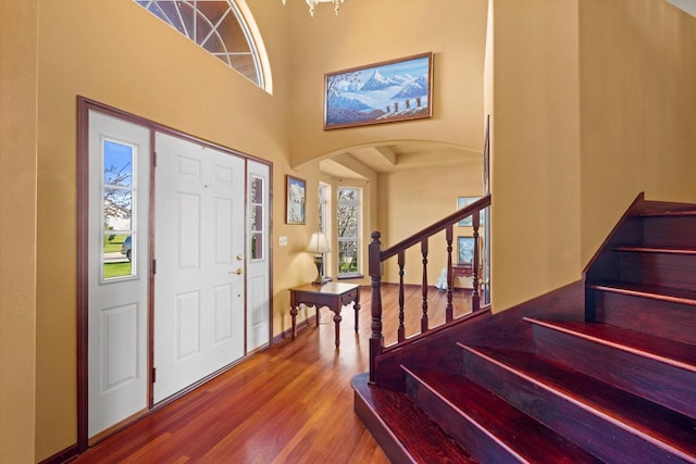 N109W14760 Preserve Pkwy, Germantown, WI 53022 - entryway with arched walkways, wood finished floors, stairway, a towering ceiling, and baseboards