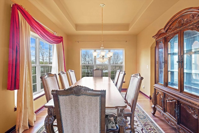 N109W14760 Preserve Pkwy, Germantown, WI 53022 - dining area featuring a chandelier, a raised ceiling, wood finished floors, and baseboards