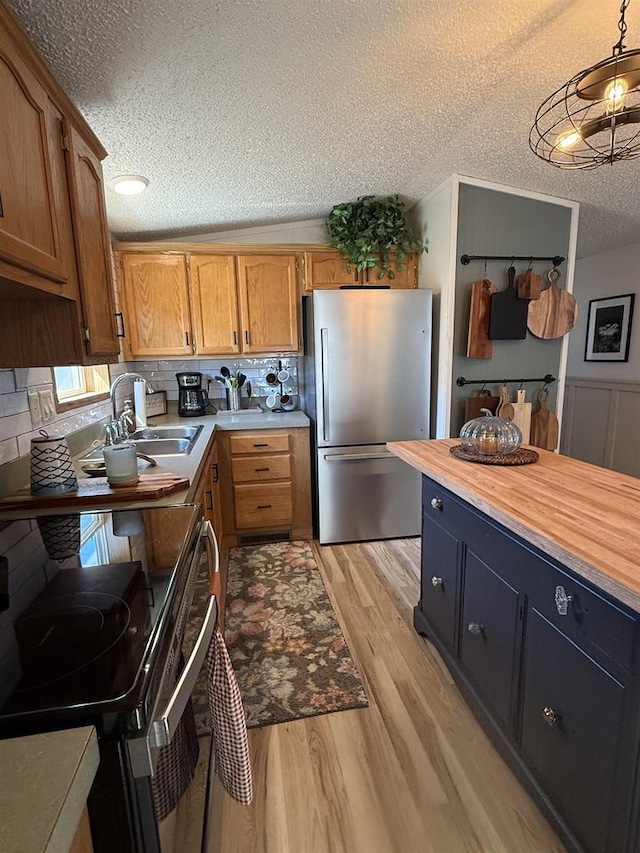 33150 Donna Dr Unit 14, Prairie Du Chien, WI 53821 - kitchen with freestanding refrigerator, electric range oven, a textured ceiling, a sink, and light wood finished floors