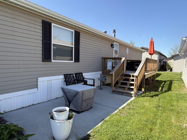 33150 Donna Dr Unit 14, Prairie Du Chien, WI 53821 - back of house featuring a patio area, a yard, and a wooden deck