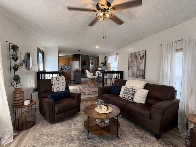 33150 Donna Dr Unit 14, Prairie Du Chien, WI 53821 - living room featuring a textured ceiling, wood finished floors, a ceiling fan, and vaulted ceiling
