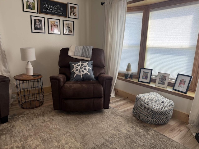33150 Donna Dr Unit 14, Prairie Du Chien, WI 53821 - living area featuring plenty of natural light, wood finished floors, and baseboards