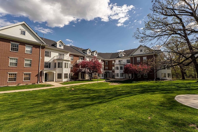 surrounding community with a residential view and a yard