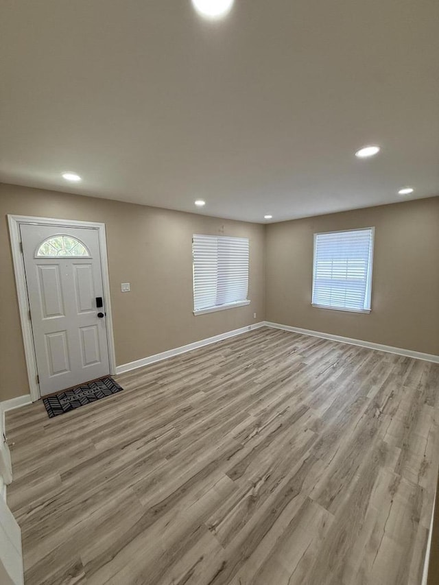 entryway featuring light wood-style flooring, recessed lighting, and baseboards