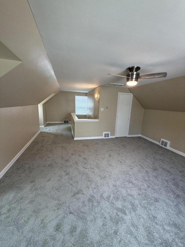 bonus room with lofted ceiling, ceiling fan, carpet, and baseboards