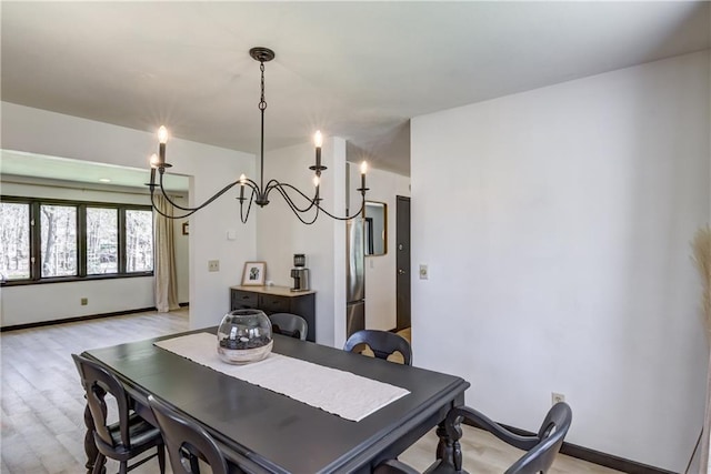 E1924 Kirk Ct, Eau Claire, WI 54701 - dining area with light wood-type flooring, a chandelier, and baseboards