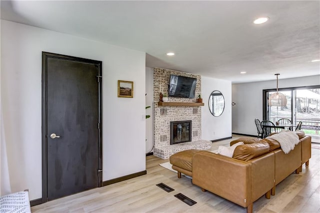 E1924 Kirk Ct, Eau Claire, WI 54701 - living area with light wood-type flooring, baseboards, recessed lighting, and a fireplace