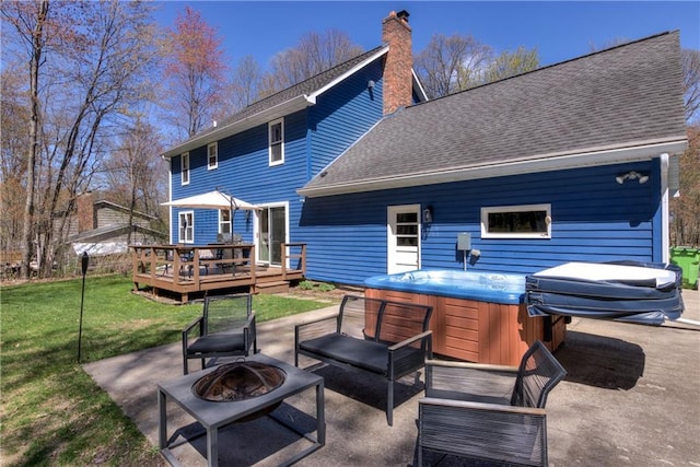 E1924 Kirk Ct, Eau Claire, WI 54701 - back of house with a hot tub, a wooden deck, an outdoor fire pit, and a patio area