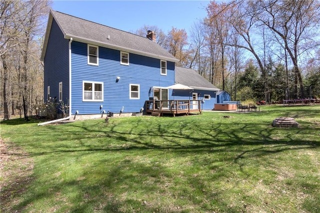 E1924 Kirk Ct, Eau Claire, WI 54701 - back of house featuring a wooden deck, a chimney, a lawn, and an outdoor fire pit
