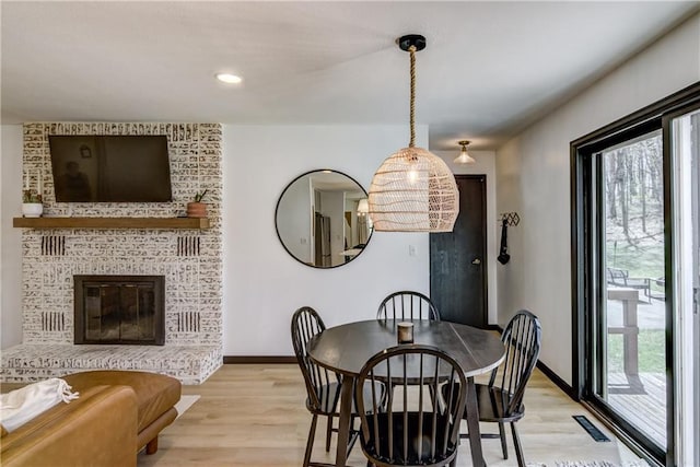 E1924 Kirk Ct, Eau Claire, WI 54701 - dining room with light wood-style flooring, baseboards, recessed lighting, and a brick fireplace