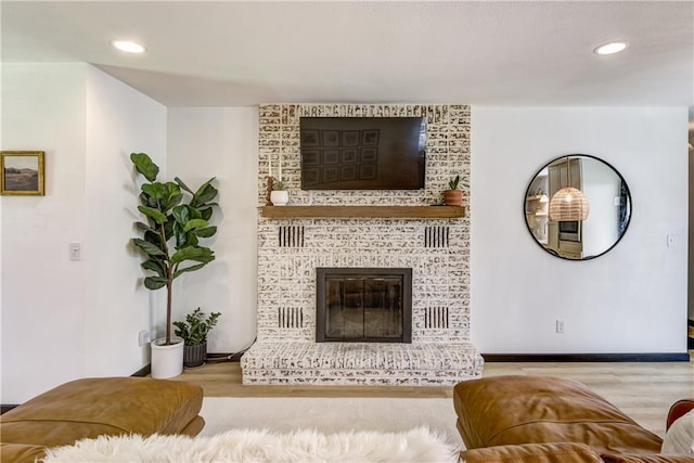 E1924 Kirk Ct, Eau Claire, WI 54701 - living room with wood finished floors, recessed lighting, a brick fireplace, and baseboards