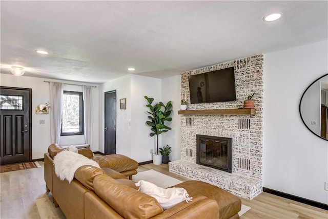 E1924 Kirk Ct, Eau Claire, WI 54701 - living area featuring light wood-type flooring, baseboards, recessed lighting, and a fireplace