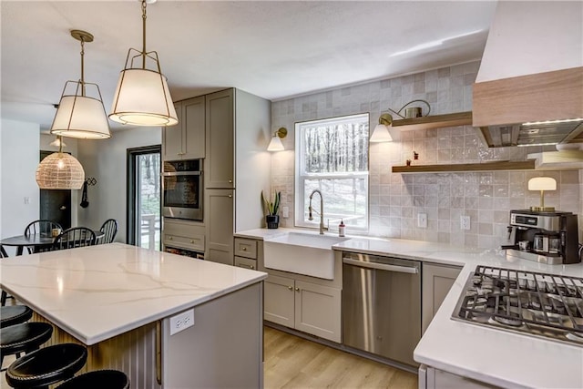 E1924 Kirk Ct, Eau Claire, WI 54701 - kitchen featuring stainless steel appliances, a sink, gray cabinets, and premium range hood
