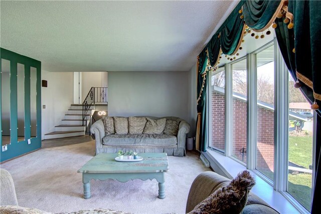 303 W Maple St, Thorp, WI 54771 - carpeted living area featuring healthy amount of natural light, a textured ceiling, and stairway