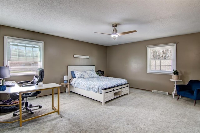 303 W Maple St, Thorp, WI 54771 - bedroom with an office area, carpet flooring, a textured ceiling, and ceiling fan